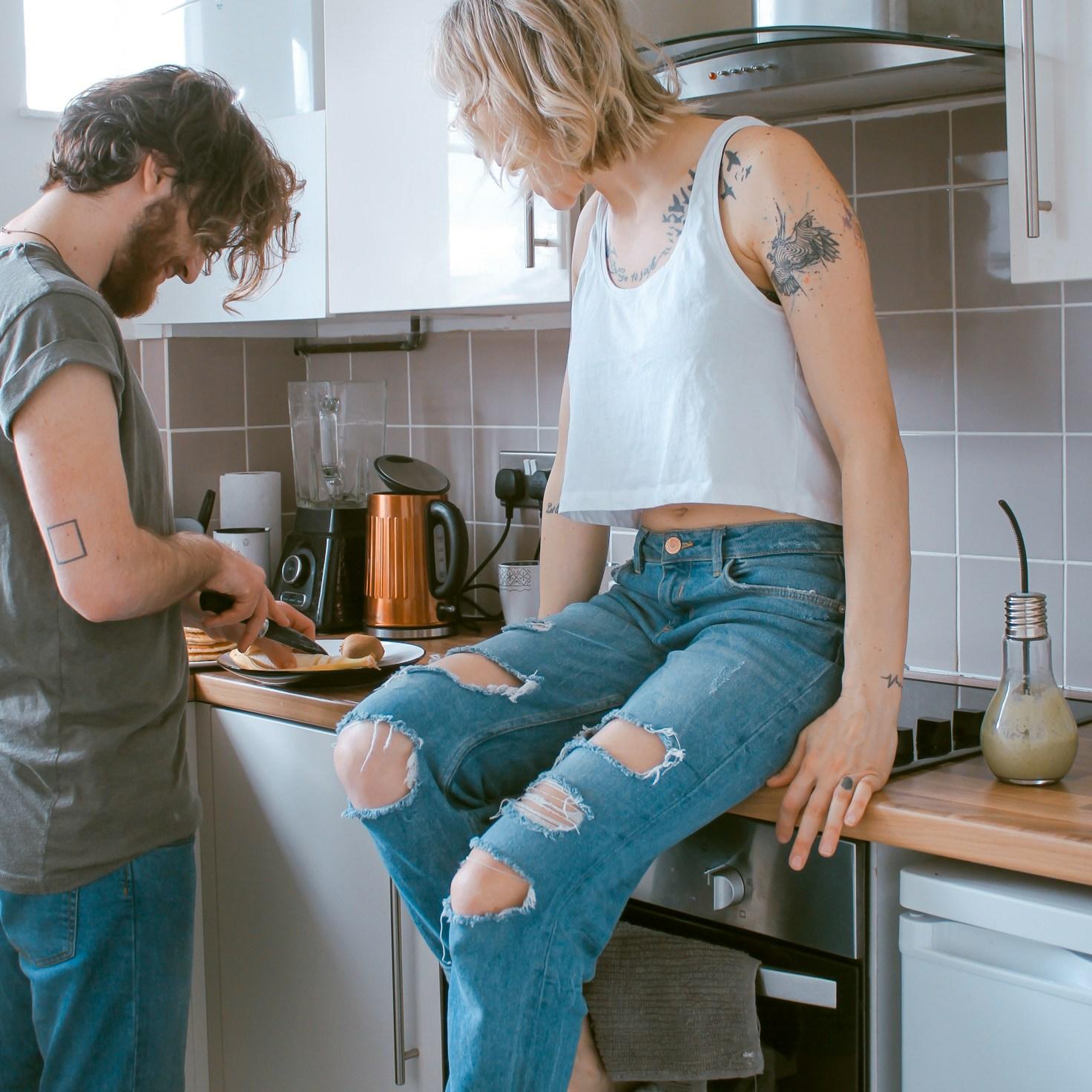 Community members collaborating in a contemporary kitchen space, sharing recipes and cooking techniques